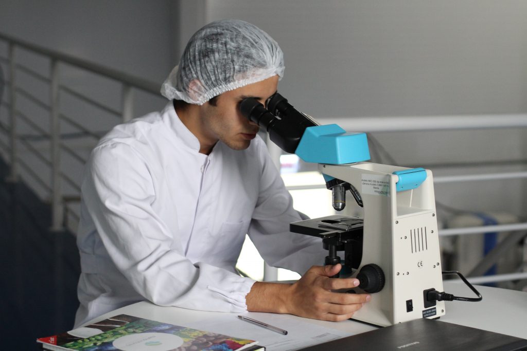 person looking in the microscope
